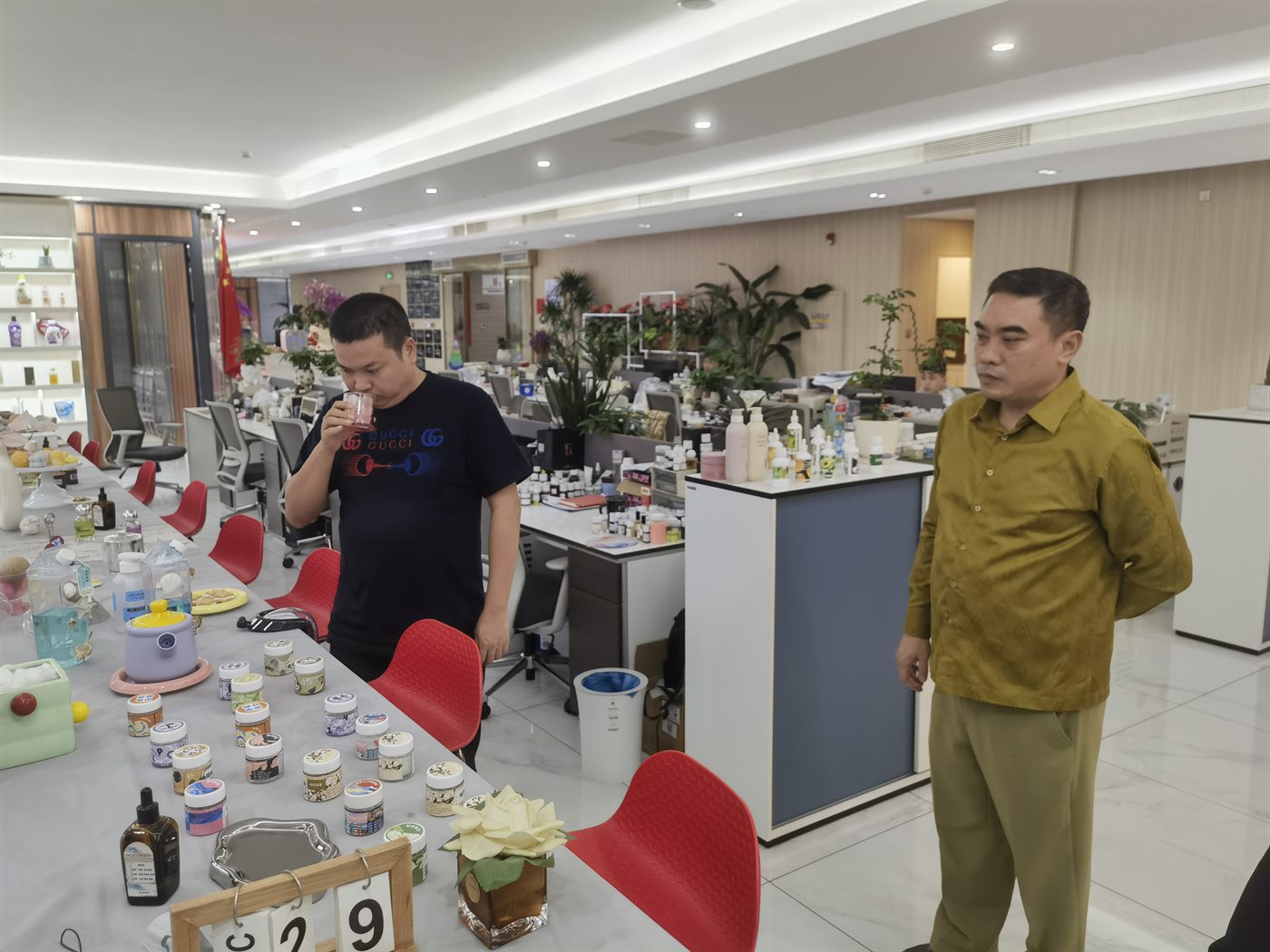 Cambodia-based client reviewing fragrance products at a China-side facility
